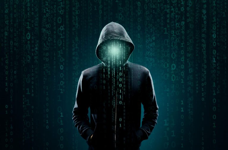 Computer hacker in hoodie. Obscured dark face. Data thief, internet fraud, darknet and cyber security concept
